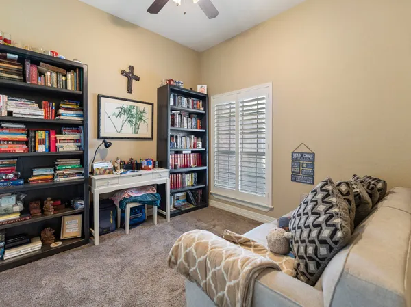 a bed room with a bed and a book shelf