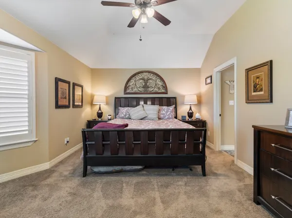 a bedroom with a bed rug and window