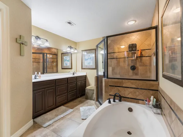 a bathroom with a tub sink and mirror