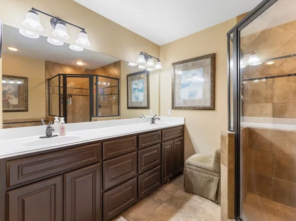 a bathroom with a double vanity sink and a mirror