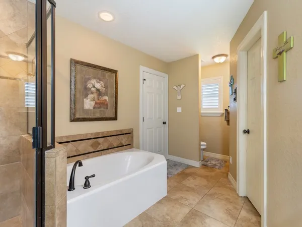 a bathroom with a tub and shower