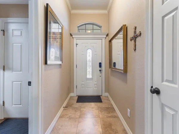 a view of a hallway with wooden floor windows and entryway