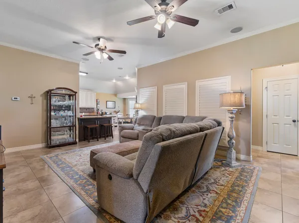 a living room with furniture and kitchen view