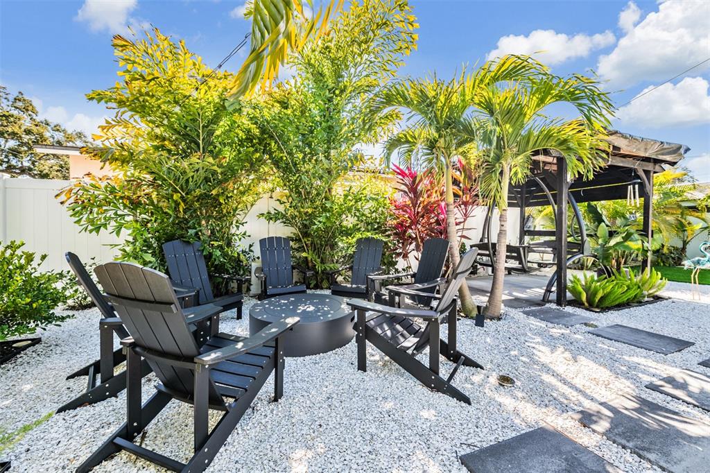2020 Culberson Avenue Dunedin, FL 34698 - Photo 25 of 52 a view of a chairs and table in a backyard