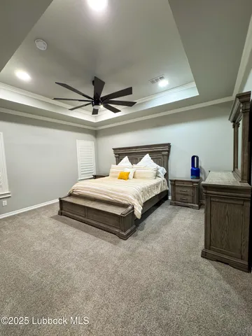 a bedroom with bed and a chandelier