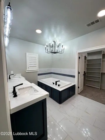 a view of a bathroom with a sink and a mirror