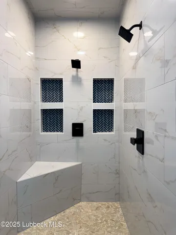 a bathroom with a bathtub and shower