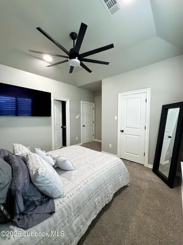 a spacious bedroom with a bed and a walk in closet