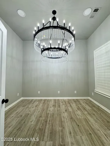 a view of room with wooden floor