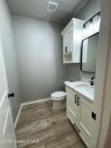 a bathroom with a sink a toilet and mirror
