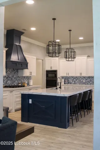 a kitchen with a sink a counter space and stainless steel appliances