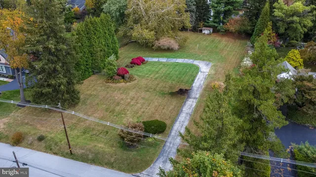 an aerial view of a house with a yard basket ball court and outdoor seating