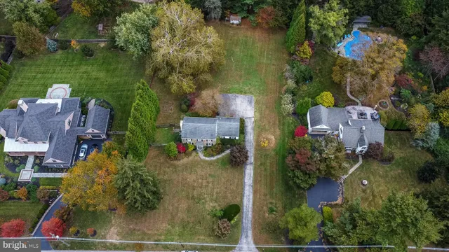 an aerial view of a residential houses with outdoor space