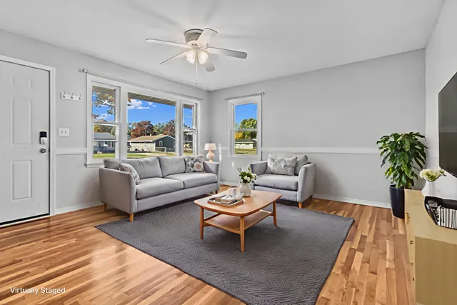 a living room with furniture a chandelier and a rug