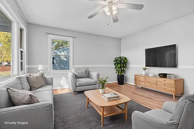a living room with furniture a flat screen tv and a large window