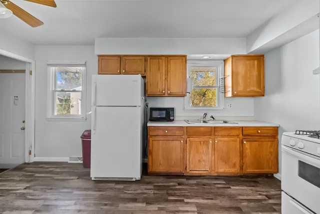 a white refrigerator freezer sitting inside of a kitchen