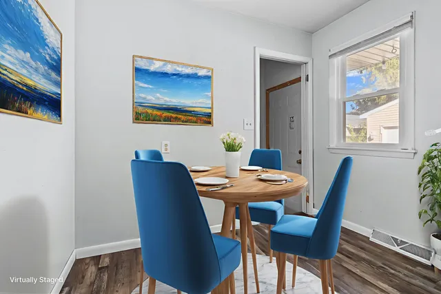 a dining room with furniture and window