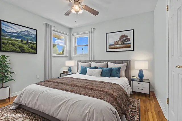 a bedroom with a large bed and a chandelier