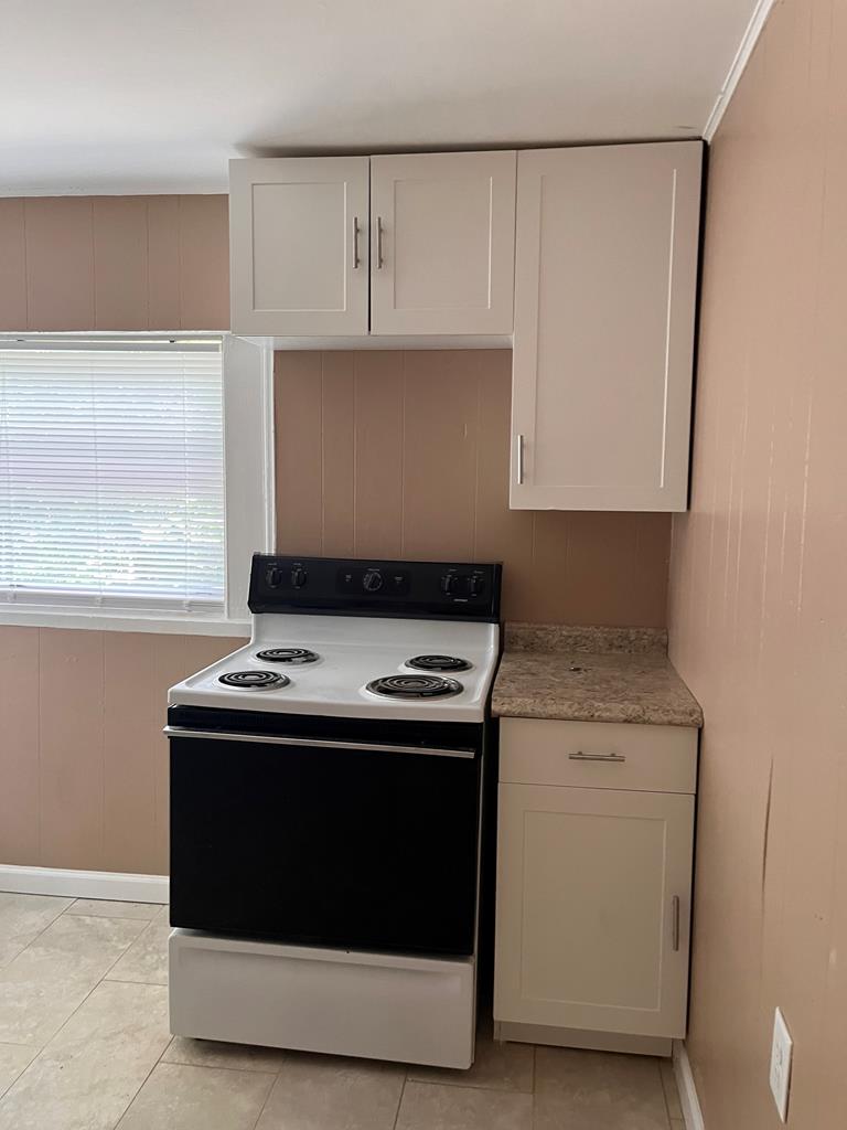 1231 18th Street, Unit D Columbus, GA 31901 - Photo 12 of 14 a stove top oven sitting inside of a kitchen