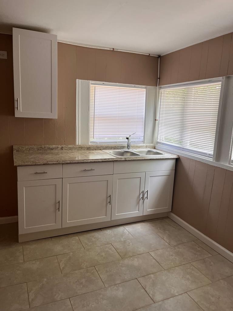 1231 18th Street, Unit D Columbus, GA 31901 - Photo 13 of 14 a kitchen with a sink stove and cabinets