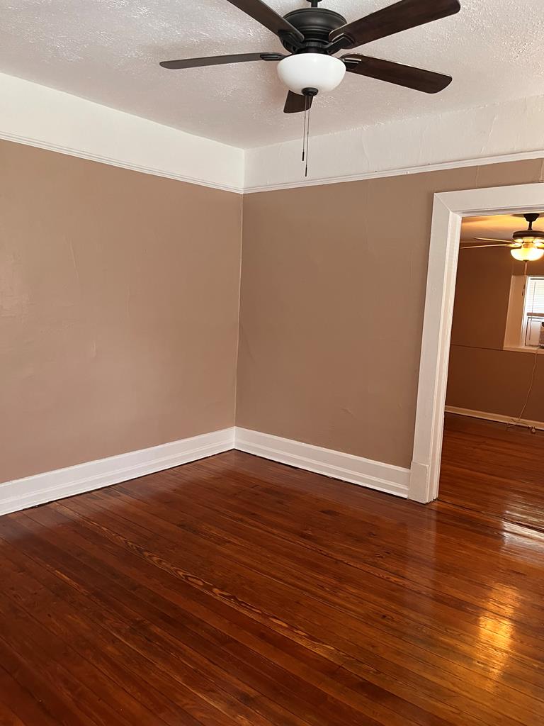 1231 18th Street, Unit D Columbus, GA 31901 - Photo 6 of 14 a view of an empty room with wooden floor