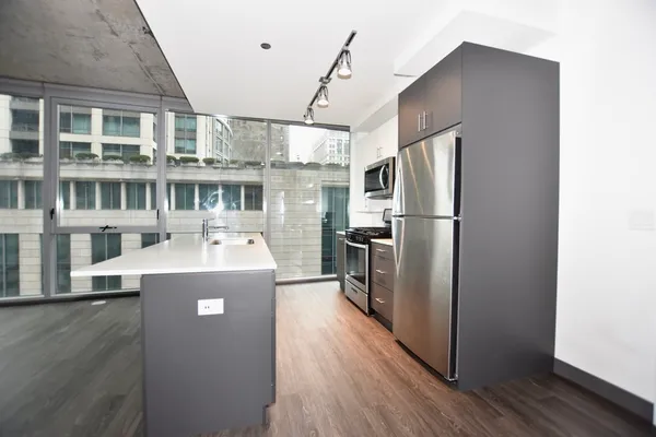 a kitchen with a sink a stove and a refrigerator