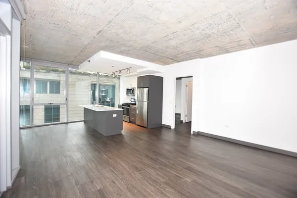 a view of kitchen with wooden floor and windows