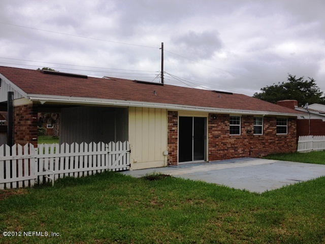 439 Irex Road Atlantic Beach, FL 32233 - Photo 11 of 12 a front view of a house with a garden