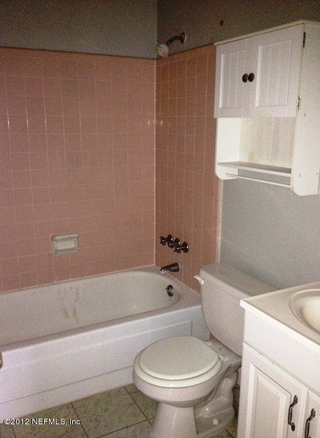 439 Irex Road Atlantic Beach, FL 32233 - Photo 8 of 12 a white toilet sitting next to a bath tub and a shower