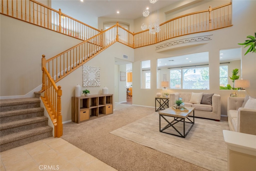 4892 Borders Street Simi Valley, CA 93063 - Photo 1 of 1 a living room with furniture and a chandelier