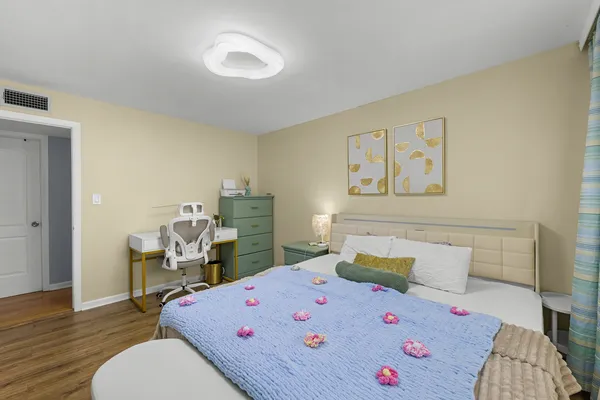 a bedroom with a bed and wooden floor