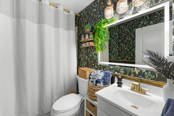 a bathroom with a sink toilet and shower