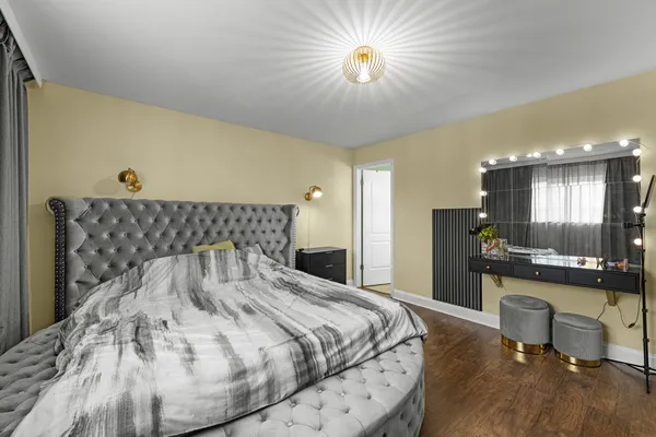 a bedroom with a bed and a chandelier