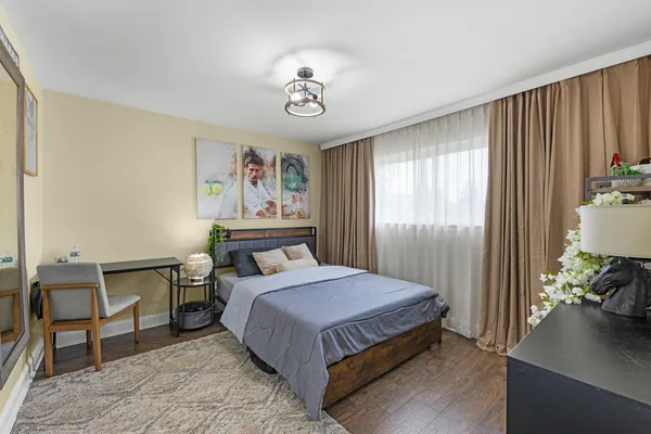 a bedroom with a bed and a chandelier