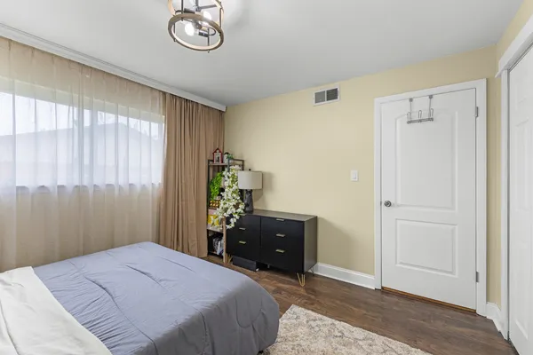 a bedroom with a bed and a dresser