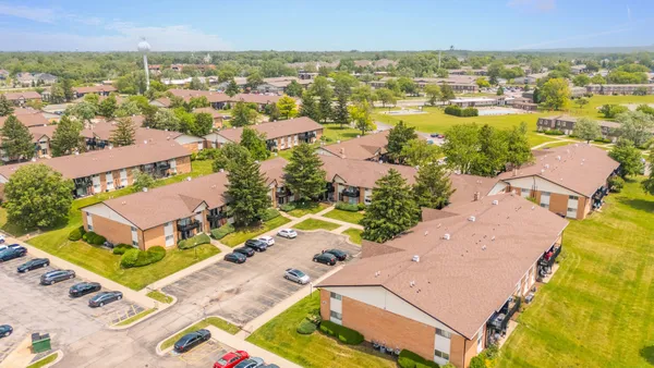 an aerial view of residential houses with outdoor space