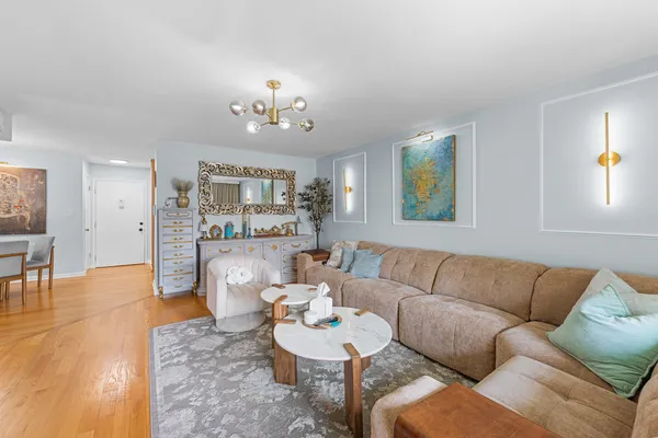 a living room with furniture and kitchen view