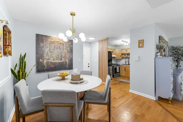 a view of a dining room with furniture and chandelier