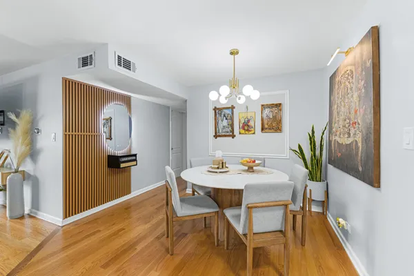a view of a dining room with furniture and wooden floor