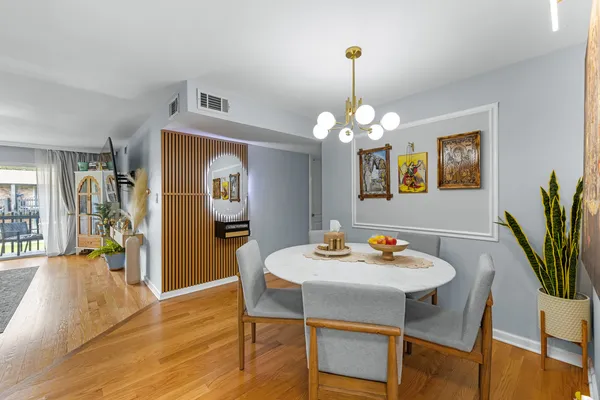 a view of a dining room with furniture and wooden floor