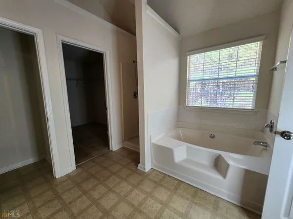 a bathroom with a bathtub and a shower