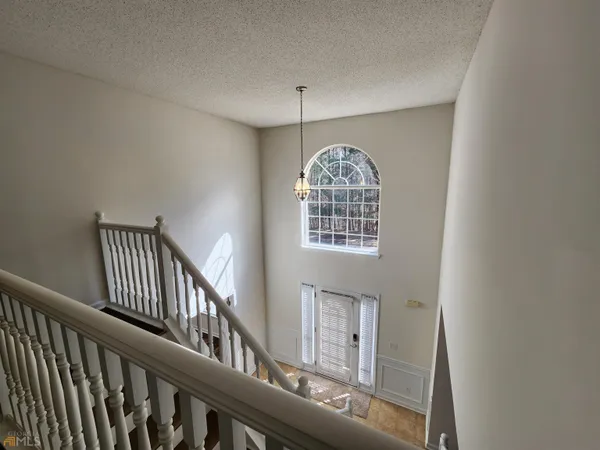 a view of entryway and hall with wooden floor