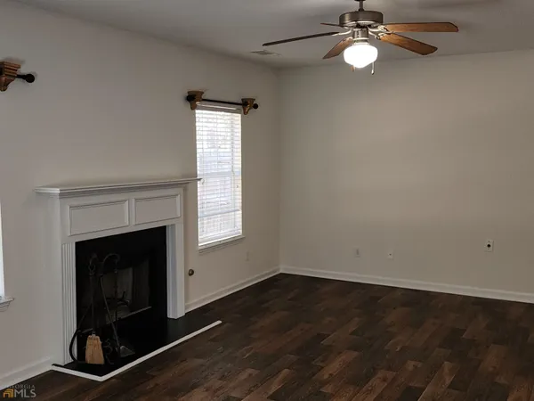 wooden floor in an empty room with a fireplace