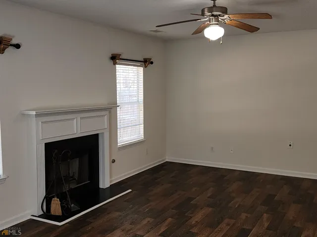 wooden floor in an empty room with a fireplace