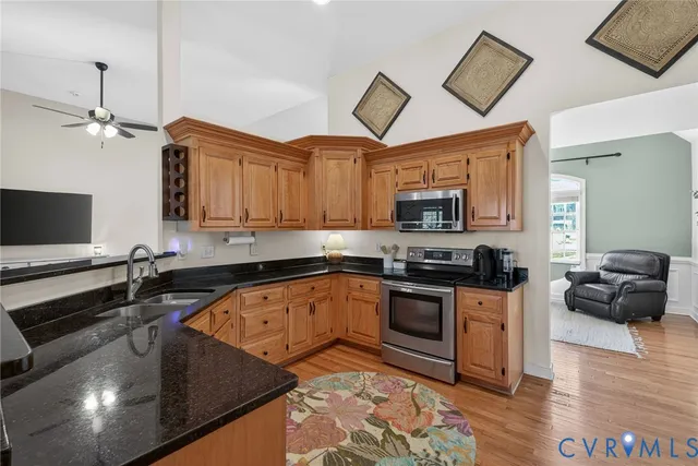 a kitchen with stainless steel appliances granite countertop a sink and a stove top oven