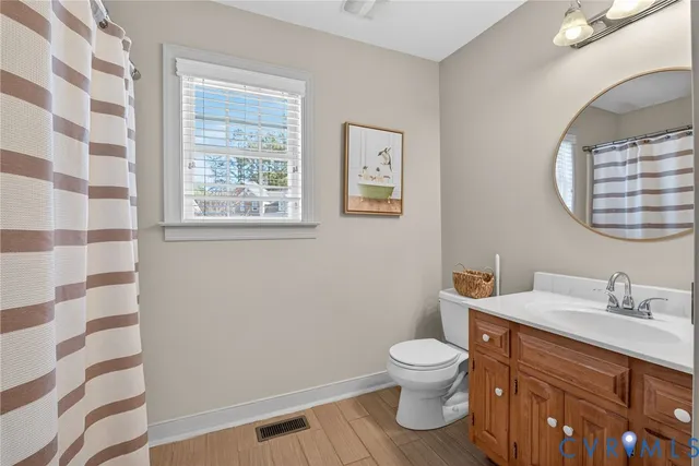a bathroom with a toilet a sink and a mirror