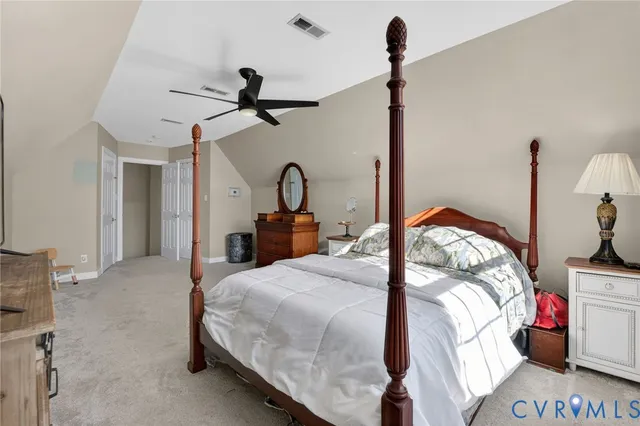 a bedroom with a bed and ceiling fan