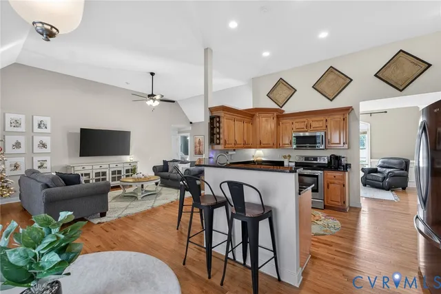a view of a living room kitchen and a wooden floor