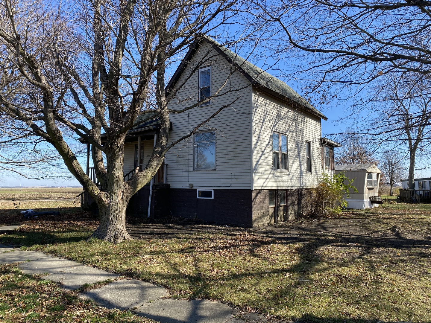 224 Poplar Street Ludlow, IL 60949 - Photo 6 of 9 a large tree in front of a brick house