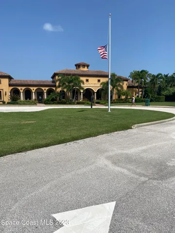 a living room with patio furniture and a large window